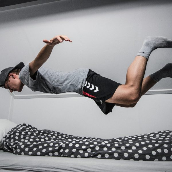 Smart gadgets for Smart Sleep, picture of a guy Falling Asleep/ Flying through air into bed
