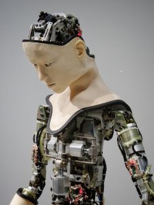 Human-like Robot with its inner mechanical working parts exposed where skin should be covering.